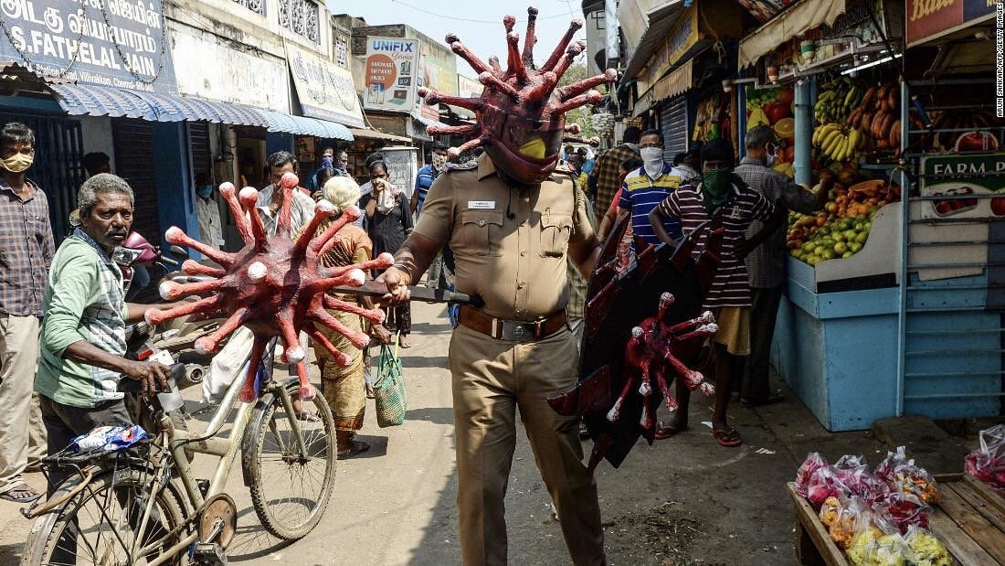 Indian police officer wearing coronavirus costume to warn people to stay inside during the country's lockdown...