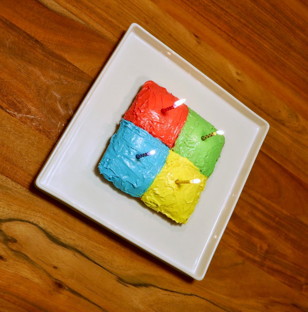 A birthday cake in the shape of the Microsoft logo