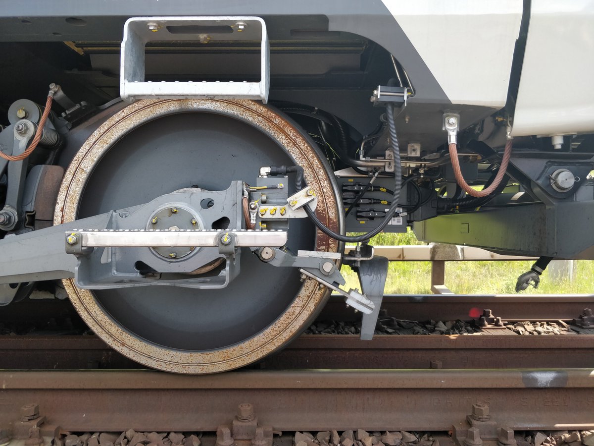 Each train is in turn fitted with a tripcock, literally a lever connected to the train's braking system and mounted near the leading wheel. A raised trip arm will strike the tripcock, causing the brakes to apply.