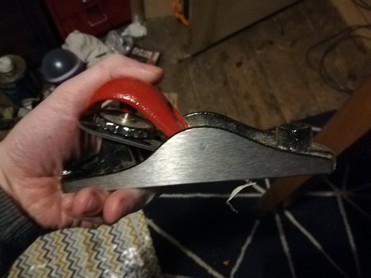You'll be wanting a block plane for this. The blade is set shallow so it can cut across the grain of the mortice and tenon joints in a panelled door. It's also got a short body so can follow minor curves, and is easy to wield even when door still attached