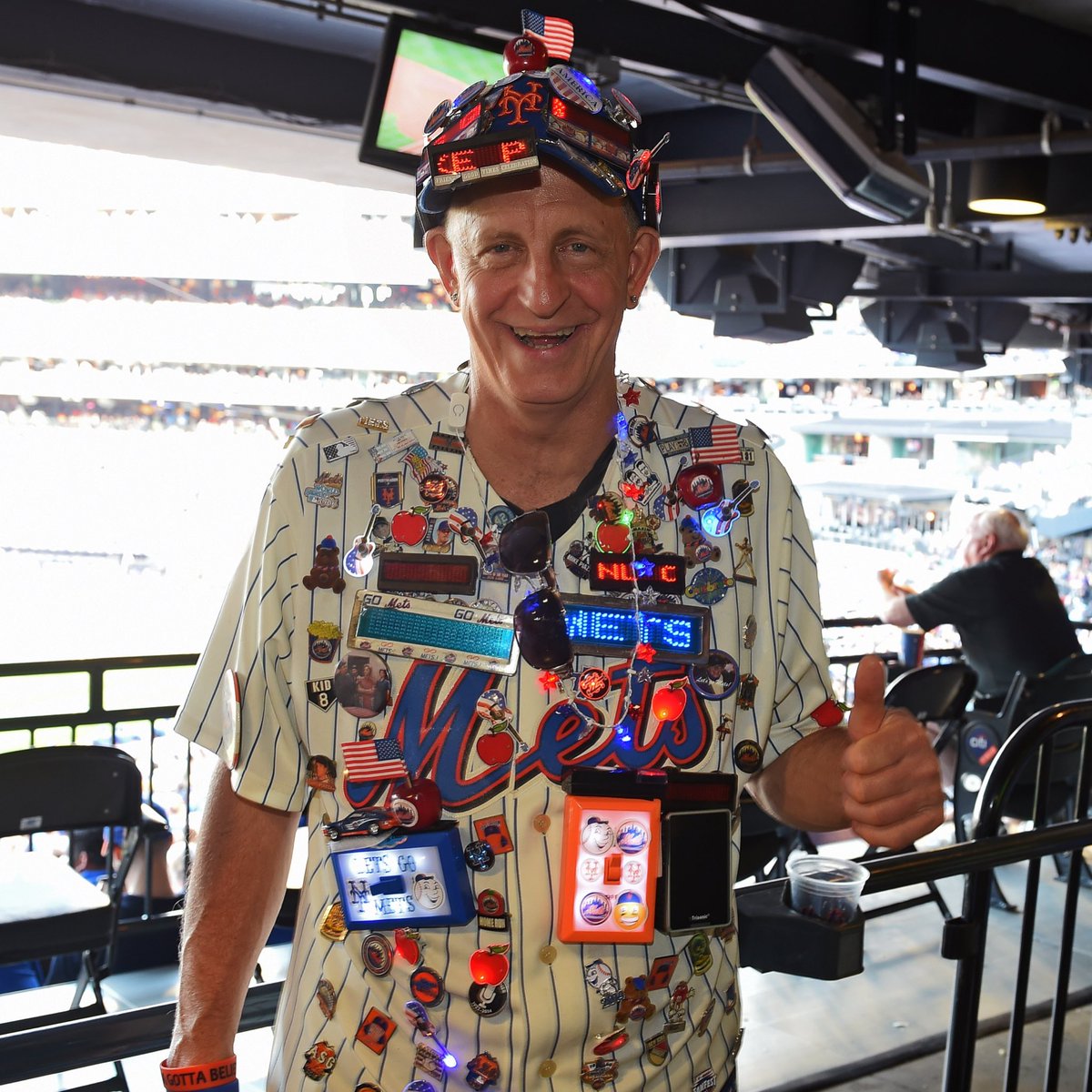 Mets's tweet image. We send our deepest sympathy to our good friend “Pin Man”. He lost his mother to COVID-19 and his father is battling in the hospital. Please know your #Mets family is thinking of you. #LGM 🧡💙