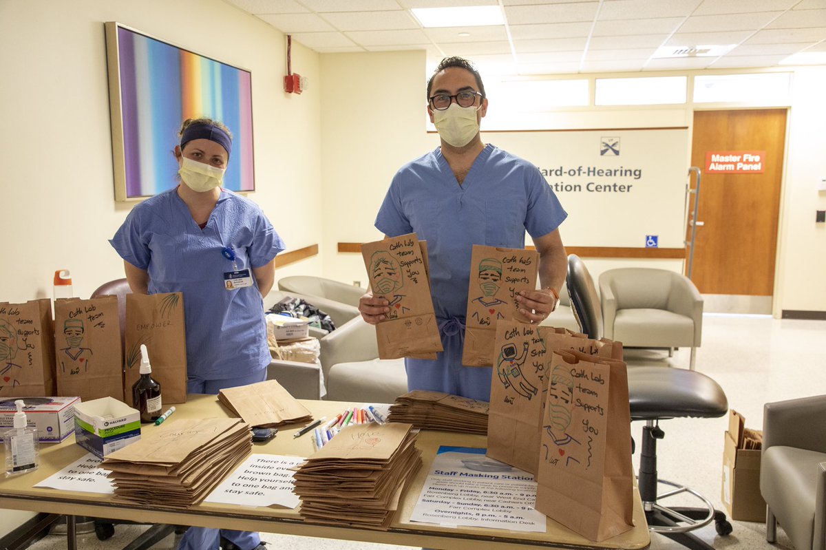 BIDMChealth's tweet photo. Luis Duffy and Chelsea Beaudoin, who usually work in BIDMC’s Cardiac Cath Lab, have been managing one of BIDMC’s staff mask pick-up areas and have been decorating the bags that contain their colleagues’ masks. Thank you, Luis and Chelsea, for this spontaneous act of kindness. https://t.co/lhSqm6KB64