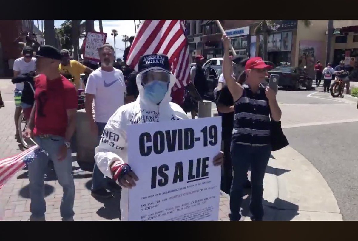 This protestor in Huntington Beach is wearing protection against #COVID-19, while saying it is a lie.