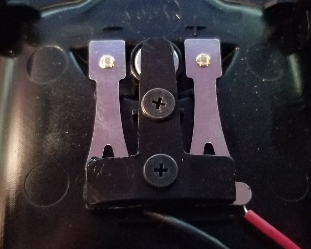 And over here is the connectory bit.I like that they labeled the polarity of the charger. Interesting that there's that circle bit in the middle...