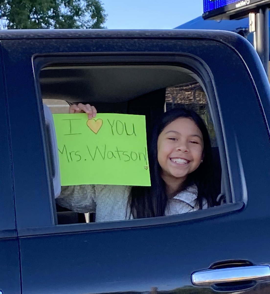 WatsonTrinicia's tweet photo. When your students put your name on a sign to show that they miss you, it takes a cloudy day caused by unfortunate news and brings the sunshine back again! Our Reagan parade was so much fun, and we had a fabulous turnout. #GoodBetterBest @ReaganMagnet #CantStopOurLearning https://t.co/C0ZPsyjsCX