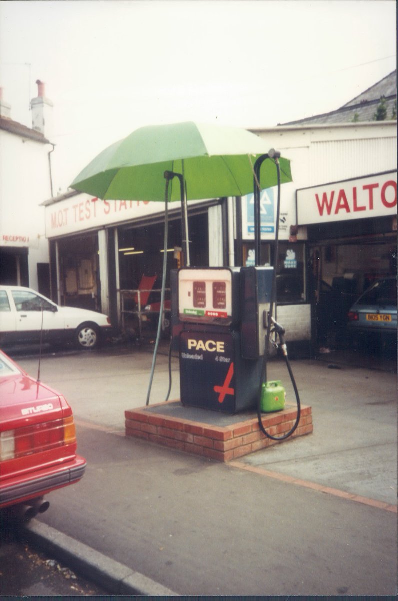 Day 118 of  #petrolstationsPaceWalton Road Garage, East Molesey, Surrey 1994  https://www.flickr.com/photos/danlockton/15644289143/  https://www.flickr.com/photos/danlockton/16238267256/I love the umbrella—hesitate to categorise it as  #jugaad, but close. Also the Maserati before Surrey was full of them. In 1994, an idiosyncratic choice