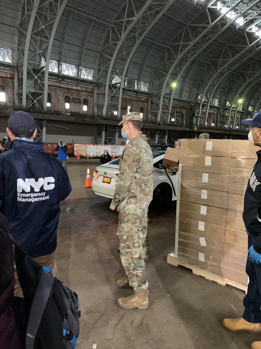 National Guard members and OEM staff members distribute emergency food relief through the help of TLC-licensed drivers and cars at the Bronx Armory.