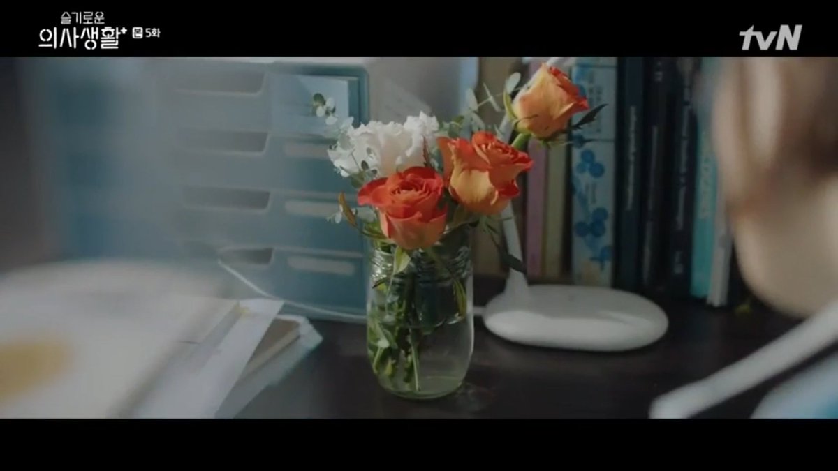 Orange RoseRed roses represent deep love that yellow ones represent friendship. orange is a combo of the two, A hidden feeling that evolves into a request to be loved. Im not yet sure with the white flower is it peony?  #HospitalPlaylist