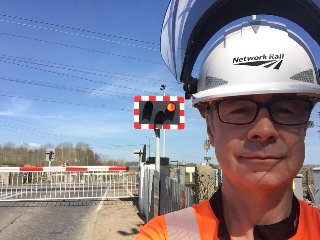 NetworkRailLST's tweet photo. This is Tom one of our hard working level crossing managers out in #Essex doing critical safety checks to #KeepBritainRunning for essential freight and key workers. Thanks Tom 🙏 #COVID19 https://t.co/tbP0j7sVuK