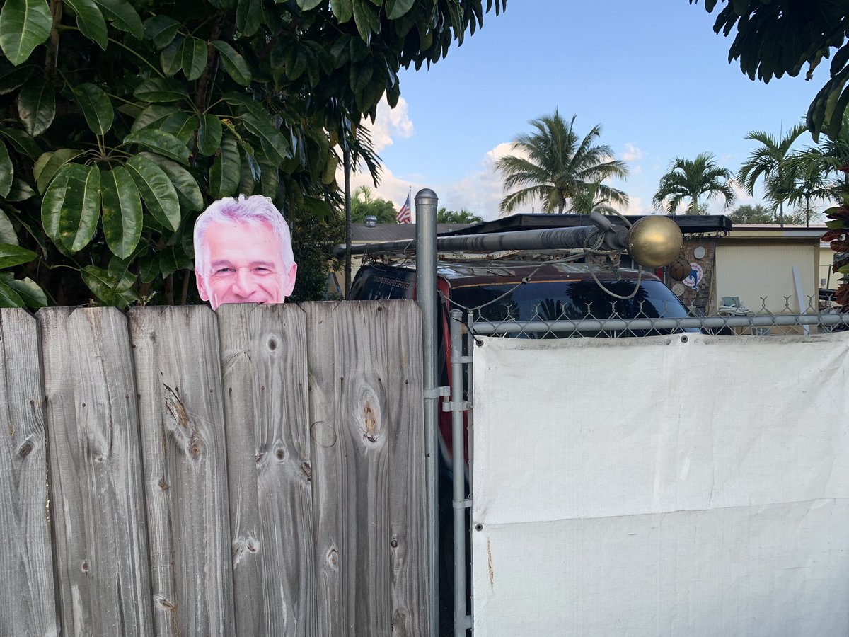 7) A picture of some guy (is that a young Ron Paul) peeking above a fence and an entire flagpole perched on a truck. I politely asked some lady taking groceries out of her car if she knew who the picture of the guy was, and she just scowled at me.