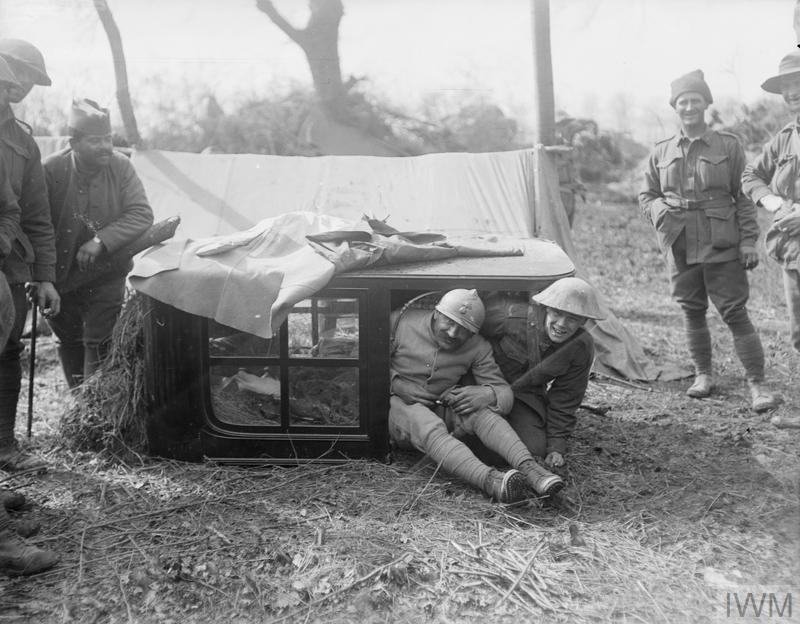 Finally, some men of the Australian 5th Division with some French soldiers in a wood behind the Vaire - Villers-Bretonneux Sector, Thomas Keith Aitken, 7 April 1918, © IWM Q 10868.