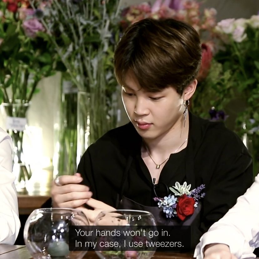 Jimin’s arrangement is in a glass bowl, and The Florist gave him tweezers to use, but Jimin is all “NO NEED, I GOT SMALL HANDS.”