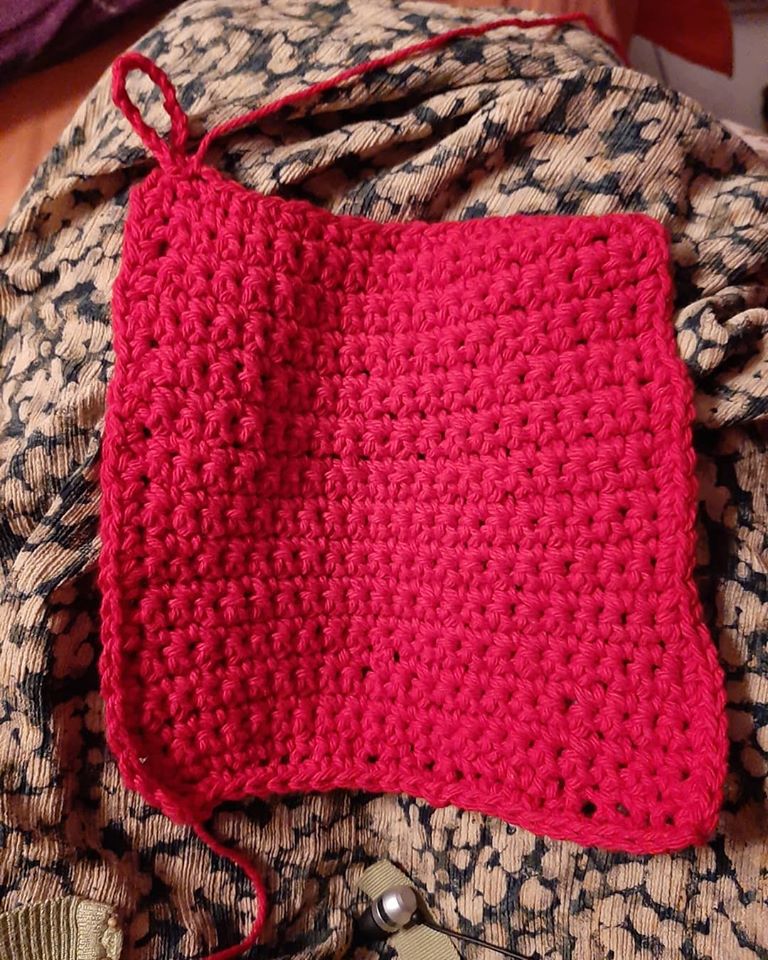 So I found a video showing how to make the most basic dishcloth using the most basic stitch. I watched it over & over, with my fat hook & squishy yarn ball, unraveling & repeating over & over again until, a few hours later, I had a completed cloth that was only slightly crooked.