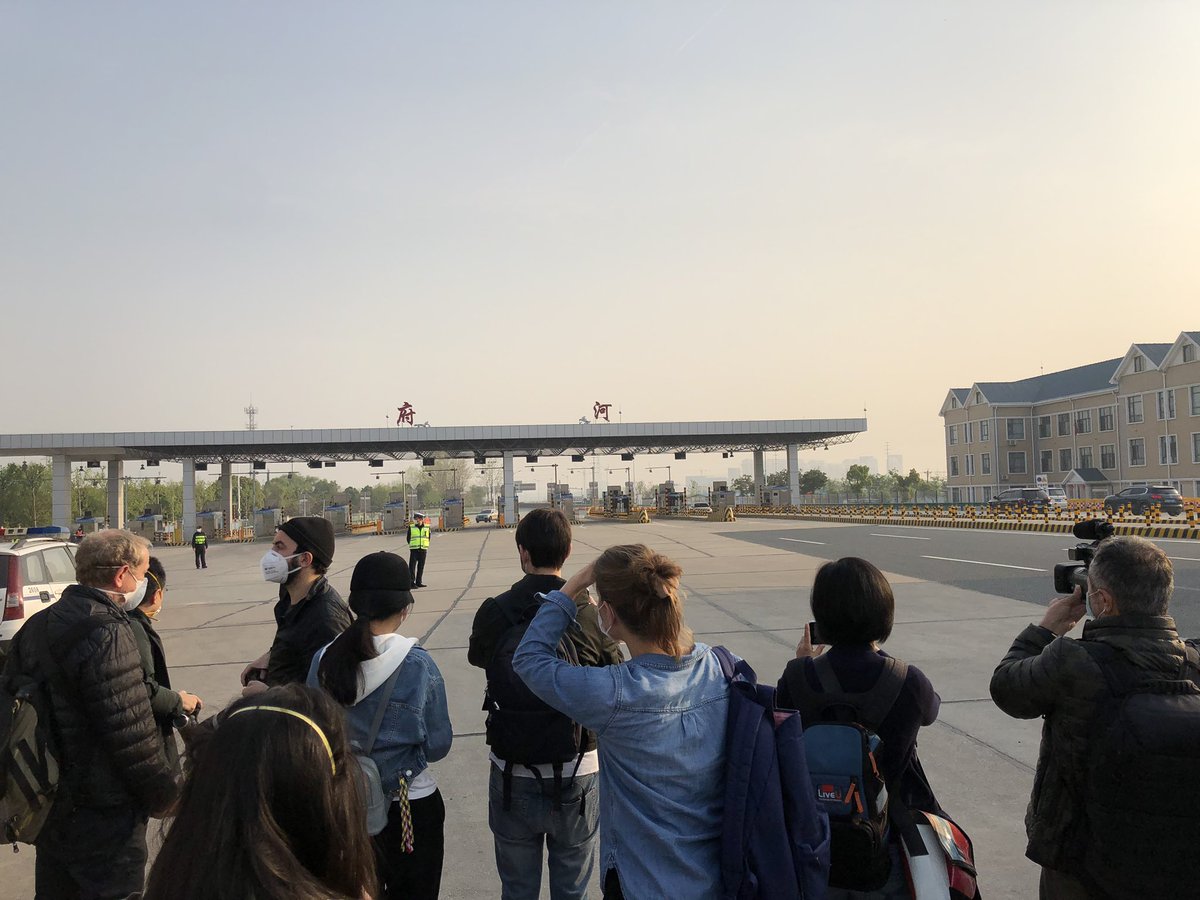 Here is a giant policeman that greets all who enter Wuhan. In other picture, journalists looking at things while wondering how to get to the other side