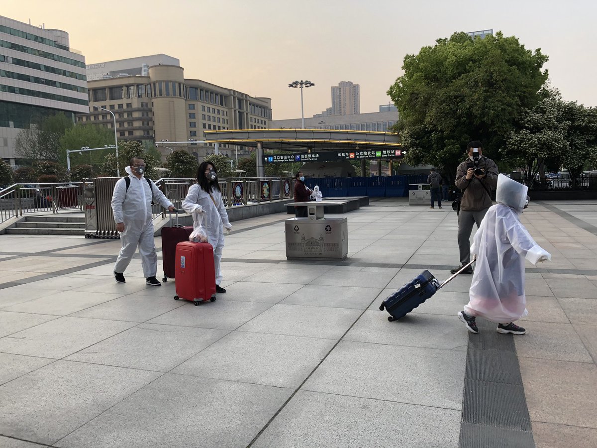 Scenes from around the station — more PPE, lots of masks, some gloves and... a robot. They’ve also got a bunch of female staff holding up welcome signs on the platform