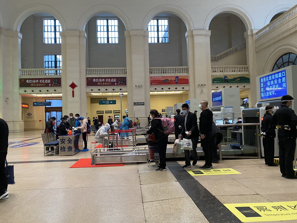 Scenes from around the station — more PPE, lots of masks, some gloves and... a robot. They’ve also got a bunch of female staff holding up welcome signs on the platform