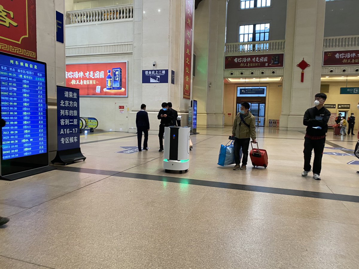 Scenes from around the station — more PPE, lots of masks, some gloves and... a robot. They’ve also got a bunch of female staff holding up welcome signs on the platform