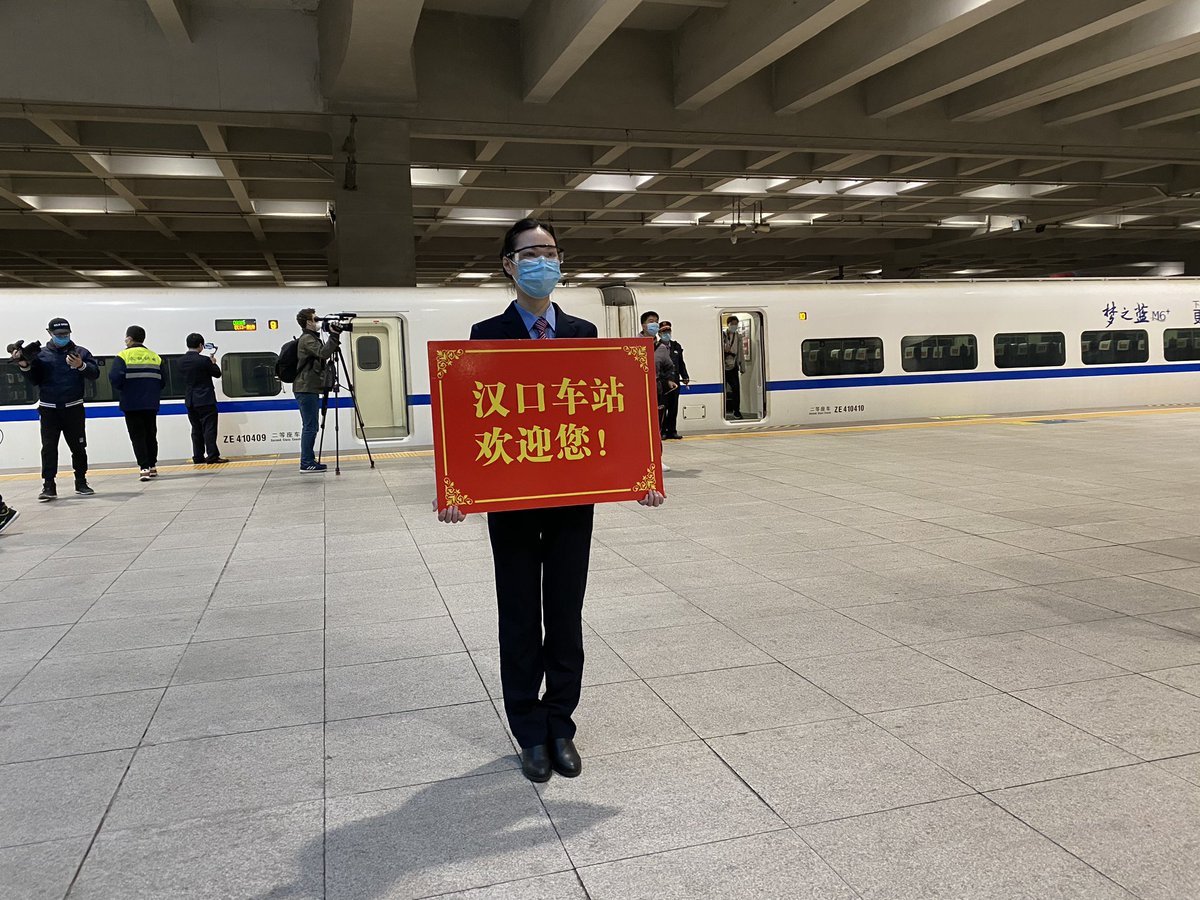 Scenes from around the station — more PPE, lots of masks, some gloves and... a robot. They’ve also got a bunch of female staff holding up welcome signs on the platform