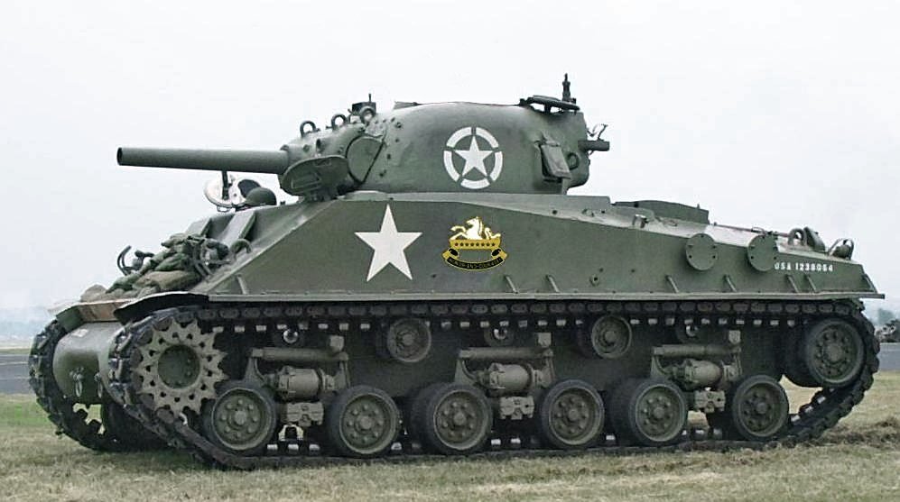 Broadly engine location constrains drive location as you want the simplest, shortest and most space efficient means to connect transmission to sprocket. That said there have been vehicles with engines not co-located, incl. WW2 favourites Sherman, PzIV and Tiger, amongst others