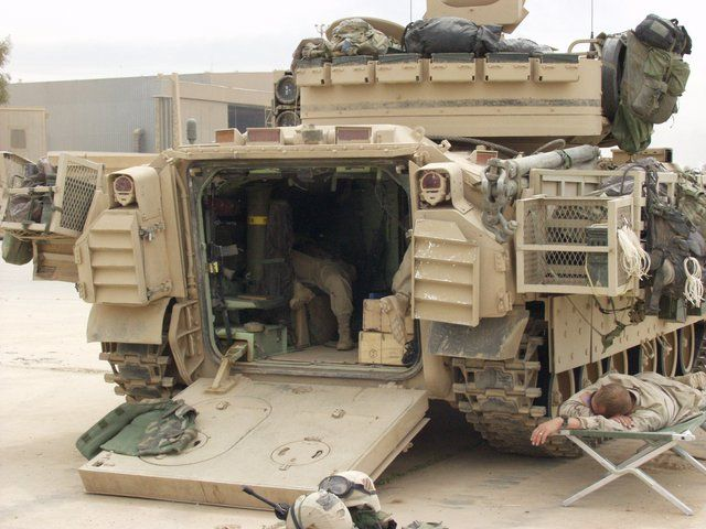 Compare here Bradley (front engine) with BMP-3 (rear engine). Getting out of BMP requires combination of rear and roof hatches to give clearance and climb over engine housing. Could be suggested to be an unacceptable tradeoff. Bradley meanwhile is a standard door and ramp affair
