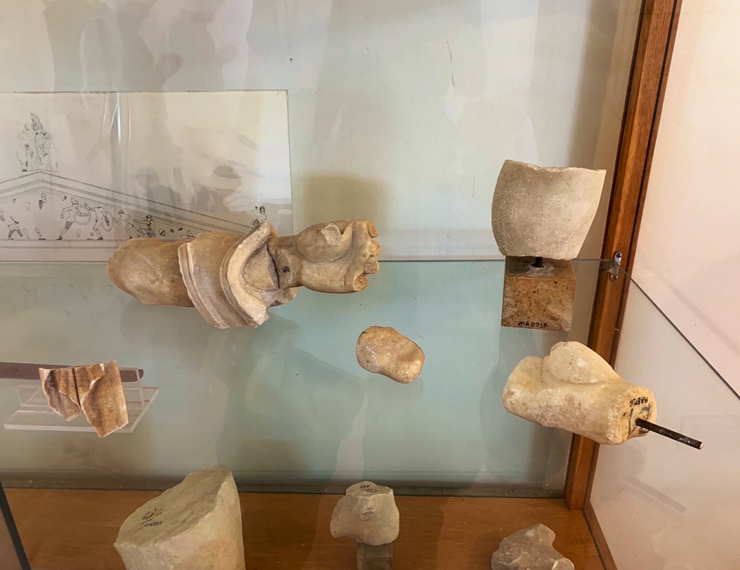 Most of the sculpture is at the Munich Glyptothek, but there are still some scrappy fragments to be seen in the display cases of the archaeological museum at Kolonna. There’s plenty of archaic smiles & clever ways of dealing with the triangular spaces at the ends of the pediment!