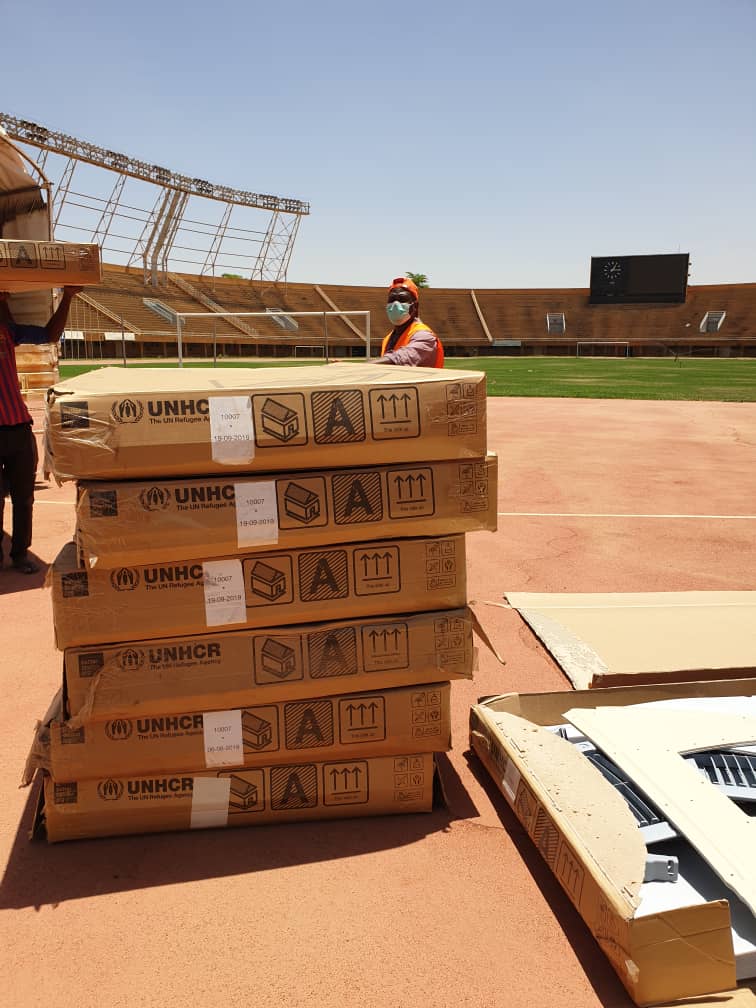 Refugees's tweet photo. Refugee housing units on the pitch of the national stadium in Niger?

Whatever it takes, we're in this together.

That's why our @UNHCRNiger team has donated 50 of these mini-housing structures that can be used as coronavirus isolation rooms. https://t.co/QJM1sUIgp3