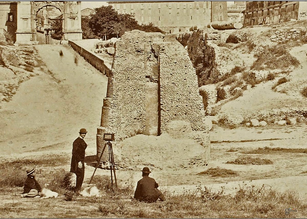 Though many thought it unsightly, the remaining brick core of the fountain, with its proximity to the Colosseum, often shows up in art and photography from subsequent centuries. A photographer can be seen here capturing an image by the Meta Sudans in the 1860s.  #LostRome