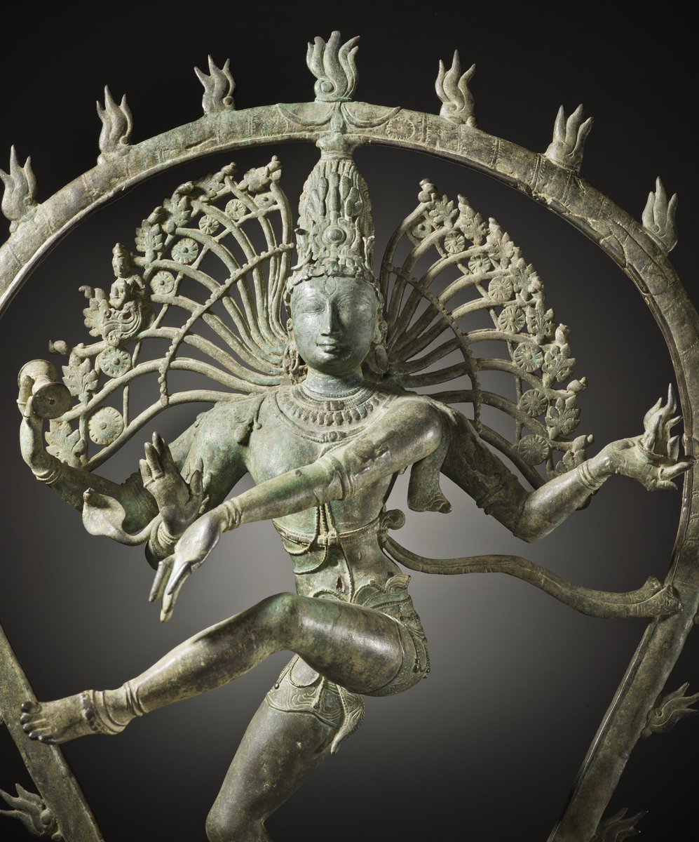 Shiva's creative dance is set within a flaming ring [prabha-mandala]: cosmic fire that creates & consumes everything in the cycle of life.Upper right hand holds the damaru [hour-glass drum that made 1st sounds of creation]-upper left hand holds agni [flame destroying universe]