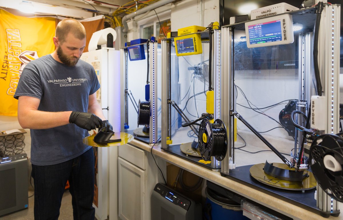 ValpoCoE's tweet photo. A team of @Valpo faculty and staff led by Mechanical Engineering professor Dan Blood are using the university's 3D printers to create face shields for local hospitals and clinics.  Even while quarantined, Valpo Engineers seek to lead and serve. https://t.co/Mxfbc5KLwT