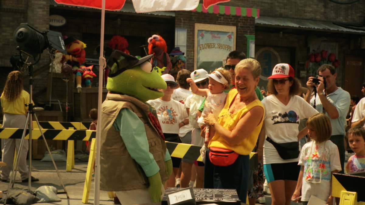 Kermit as a director in approx Sept 1991, four months after Muppet*Vision opened in Disney's Hollywood Studios.Notice the band in background, at the A. A. Chue Flower Supply set in DHS.