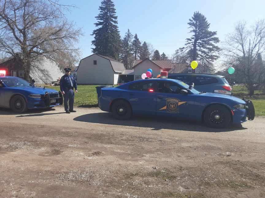 Members of the Michigan State Police continue to  #DoMIpart during the  #COVID19 emergency. Here’s a look at the  #ViewFromMyOffice of West Branch Post Troopers Noble, Landman and Good providing Service with a Purpose in a birthday parade for a six-year-old boy in Iosco County.