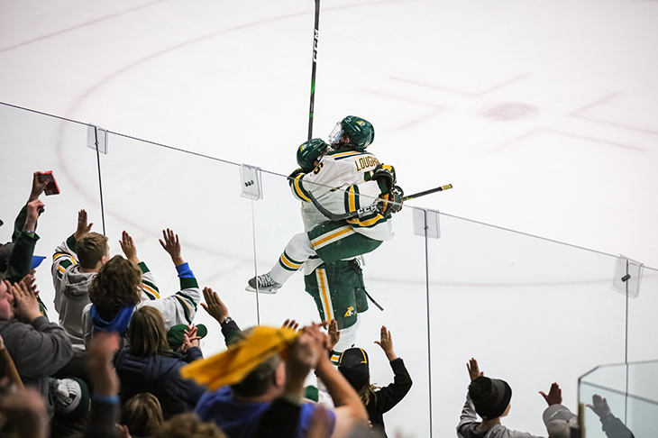 Let's drop the puck on our final matchup! You pick the college hockey Photo of the Year:
- Harvard hip check
- Northern Michigan celebration