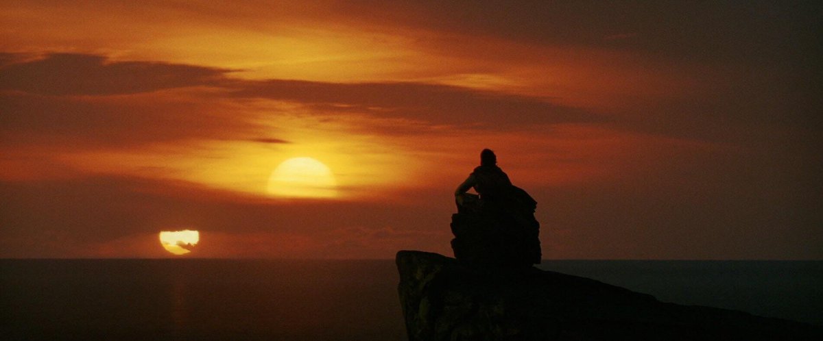 The twin suns in TLJ work. It's no longer in Tatooine. He's looking at the suns from a different perspective now, older, having achieved many of his dreams. There's no fear, no trapping, he's ready to let go. In a way, he's leaving the trapping of the physical world.