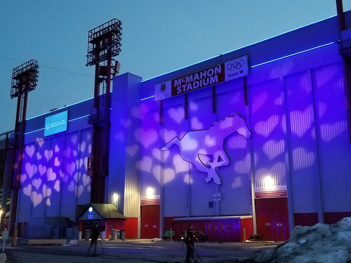 SeattleMarathon's tweet photo. The University of Calgary stadium featuring Quicksix, horse of CFL's Stampeders, is lit up tonight honoring frontline aid workers against COVID-19. @Amica Seattle Marathon ambassador Heather did laps here instead of her usual river run, making sure each step counted. #runsea https://t.co/ECQLvCg16S
