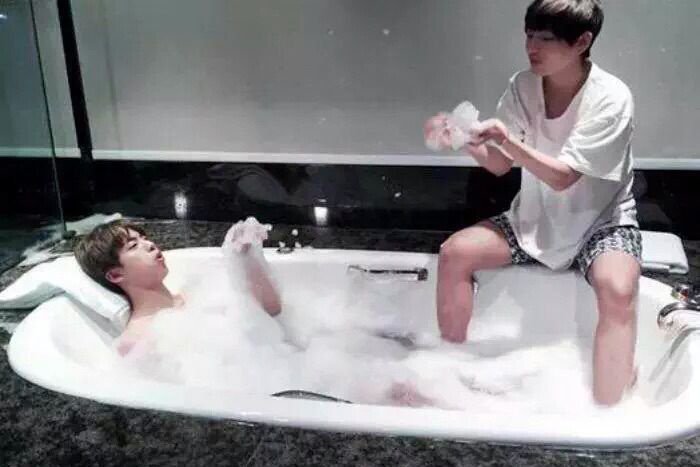 two bros chilling in a bathtub