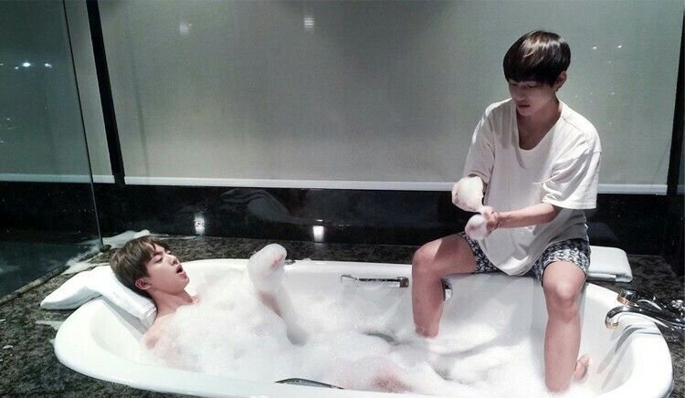 two bros chilling in a bathtub