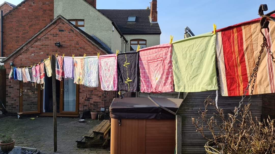 RawlinsAcademy's tweet photo. Our staff have been busy at home this week! Mrs Fern is making laundry bags - here they are drying in the sun. Mrs West &amp; Miss Needham are fulfilling requests for headbands, while Mr Elliot and Mrs Newbold are 3D printing mask clips. Great job everyone! #HelpTheNHS #PPEfortheNHS https://t.co/Ux0251CUwL