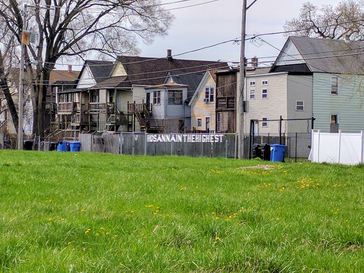 Good Friday 2017 in a Chicago ghetto: Styrofoam cups stuck in a chain link fence spell out, Hosanna in the highest