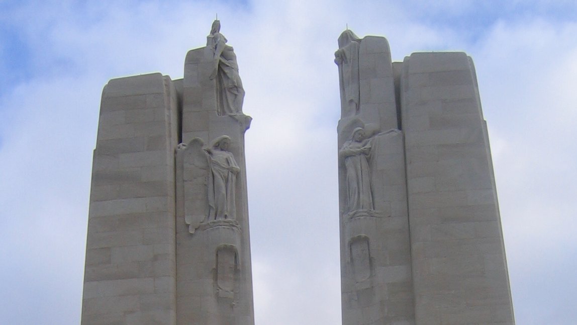 At the top of the pylons, on the front, are The Virtues (or The Chorus): Hope, Faith and Justice on the left and Charity, Honour, and Peace on the right.