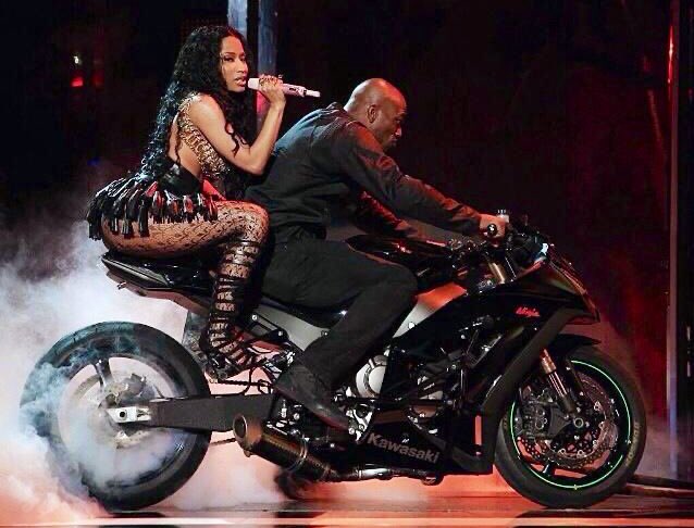 “Young money right here, bike here, throw it up, no high chair”Nicki talks about throwing bikes up: popping a wheelie. She then compares it to a highchair which is a chair babies sit in and are known for throwing up in. It is well known that she has a thing for motorbikes.