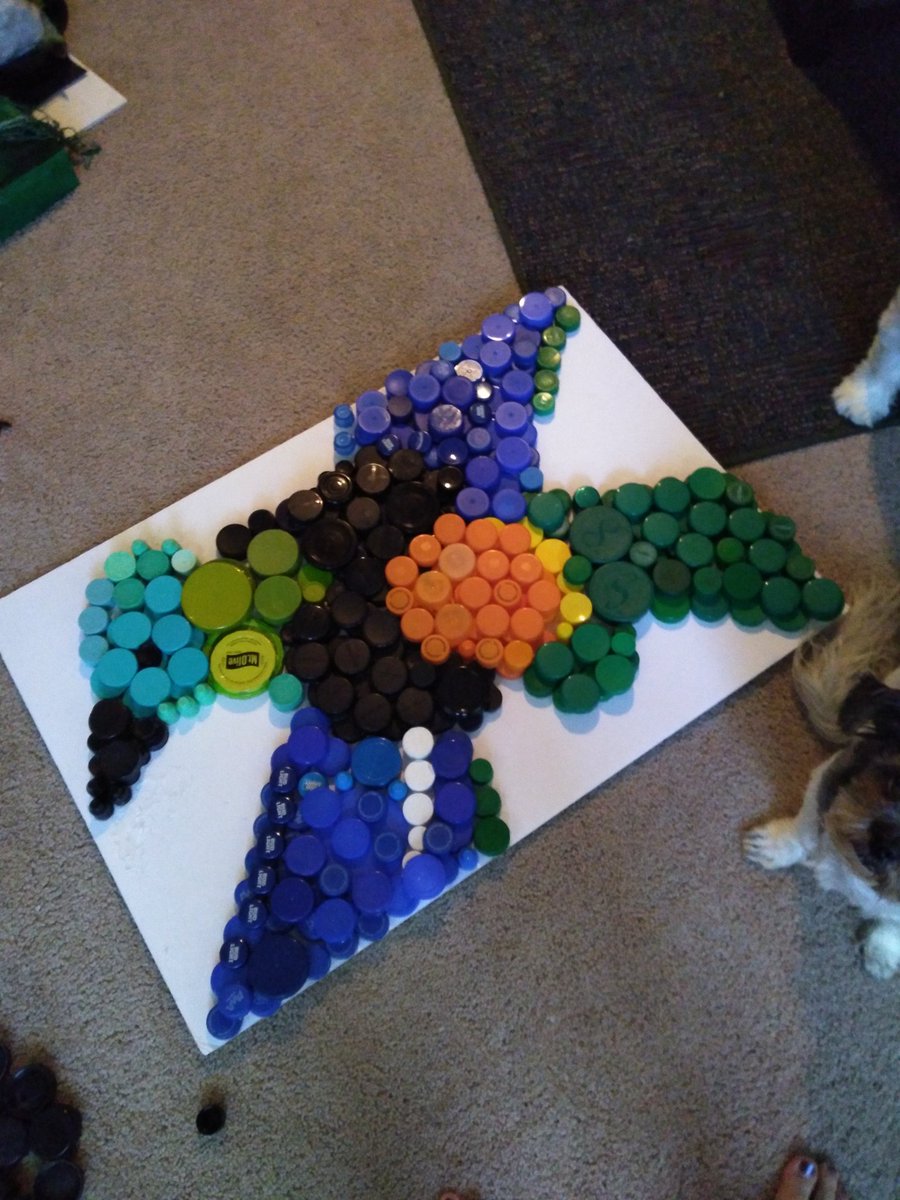 Wilson2002A's tweet photo. After gathering plastic lids for a couple of months, I finally did something with them...now that I'm stuck at home. So, I made a green-headed tanager out of bottle caps 

#art #upcycled #recycledart #plasticart #savetheplanet #quarantinelife https://t.co/OEJn5S30er