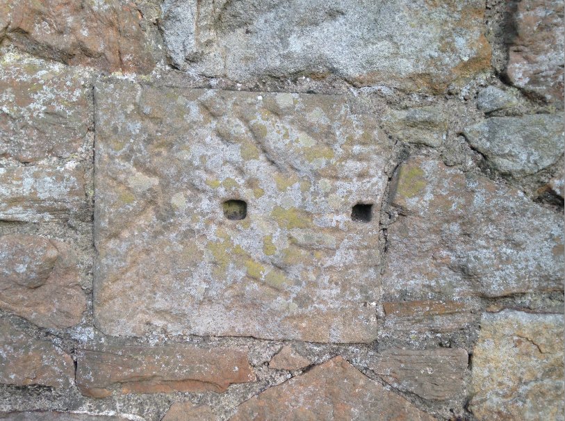 On a wall opposite the former site of the Preston House is this little oddity. Hard to say what it once was. It's clearly been seriously worked and the two holes may once have held wooden dowels to fix an external plate or perhap iron fixings. (4/12)