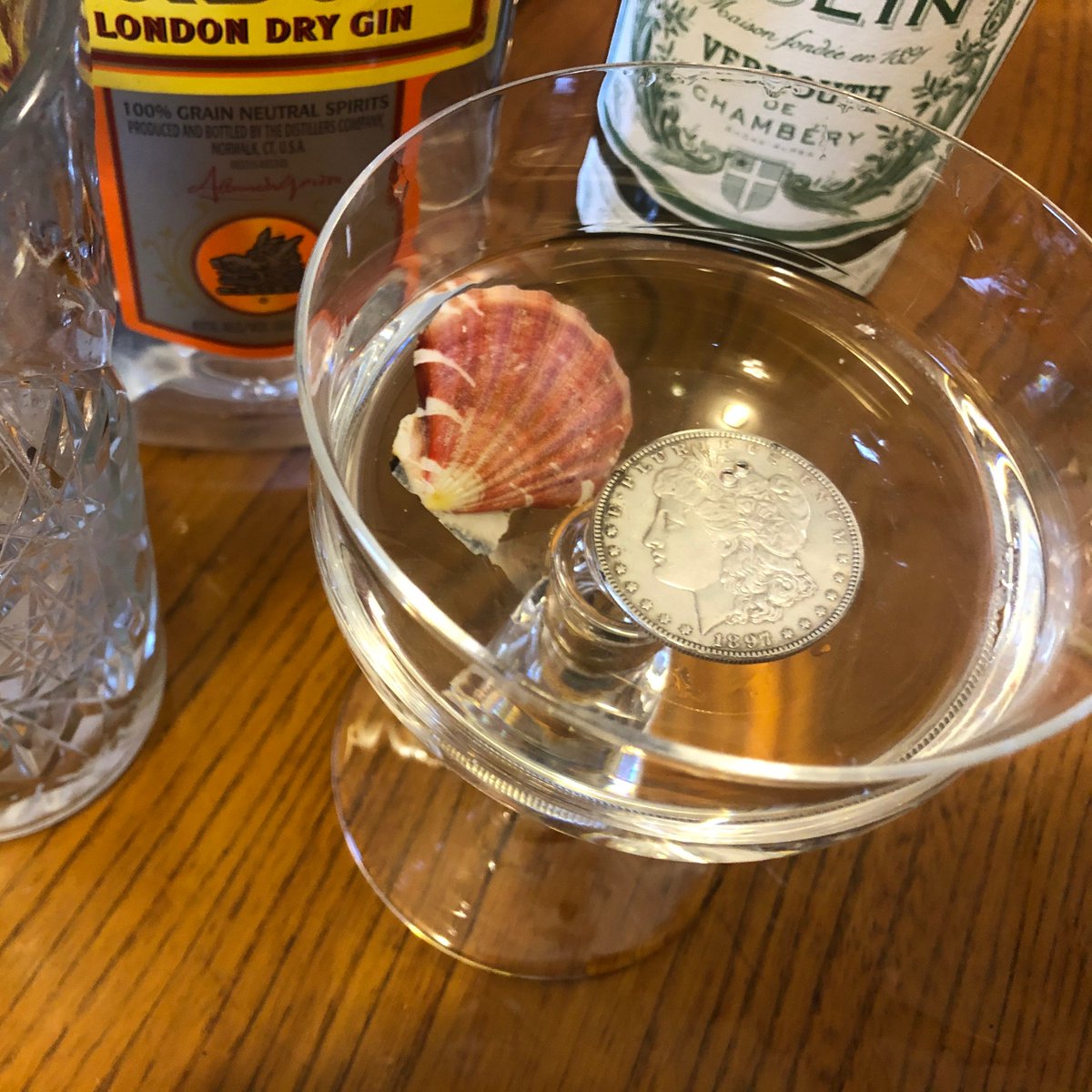 Strain the martini into a coupe and decorate with a thoroughly washed seashell (for calcium) and a silver dollar (for decoration). Do not ingest the garnishes. Enjoy. (10/73)