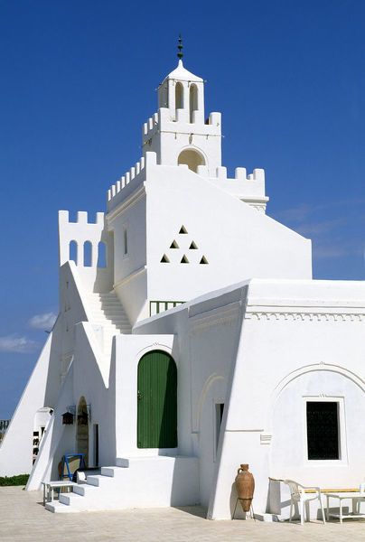 The South: Djerba's Ibadite architecture The island Djerba is known for its strikingly white simple Ibadite mosques and its houses that contrast with its crystal blue beaches.Similar architecture can be found in he city of Ghadames in Libya.