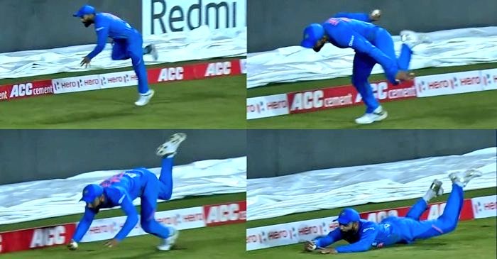 [6/10]Kohli ran across to his right from long-on, stretched every muscle in his athletic body to get both of his hands under the ball to complete a stunning catch.