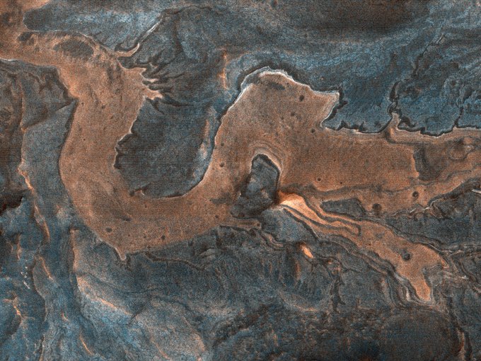An image of light-toned blocky material in southwestern Melas Chasma that from one perspective, looks like a Chinese dragon. (NASA/UArizona)