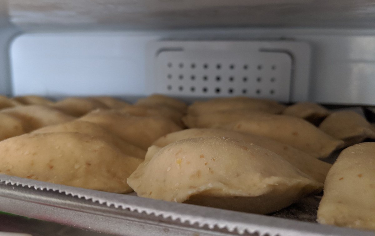 Step 9: Flatten filling a bit in the middle, then fold over and pinch dough closed.If the dough doesn't seal, use a bit of water along the edge and press together.Step 10: Set the pierogies in rows on parchment paper and put the trays in the freezer.