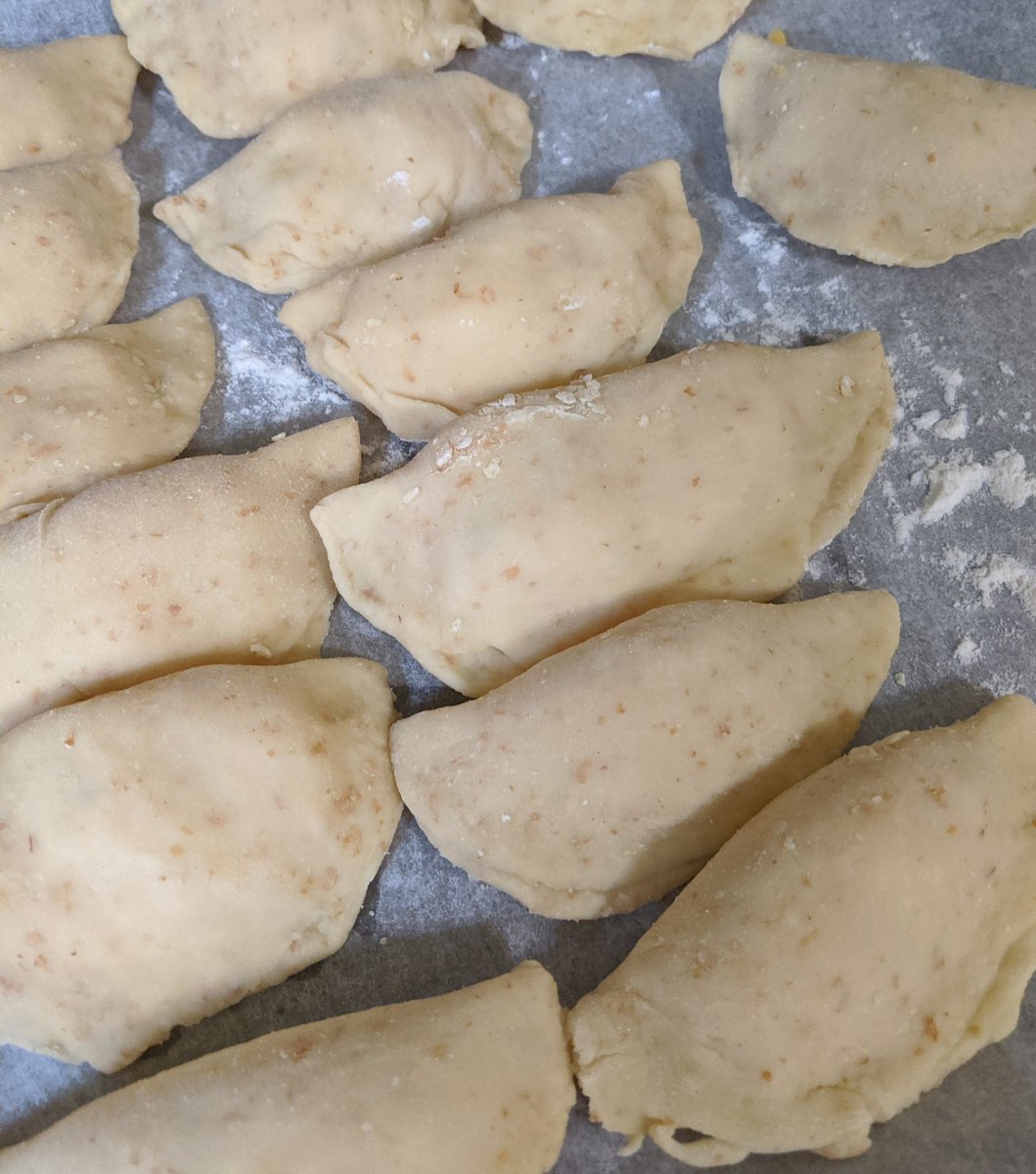 Step 9: Flatten filling a bit in the middle, then fold over and pinch dough closed.If the dough doesn't seal, use a bit of water along the edge and press together.Step 10: Set the pierogies in rows on parchment paper and put the trays in the freezer.