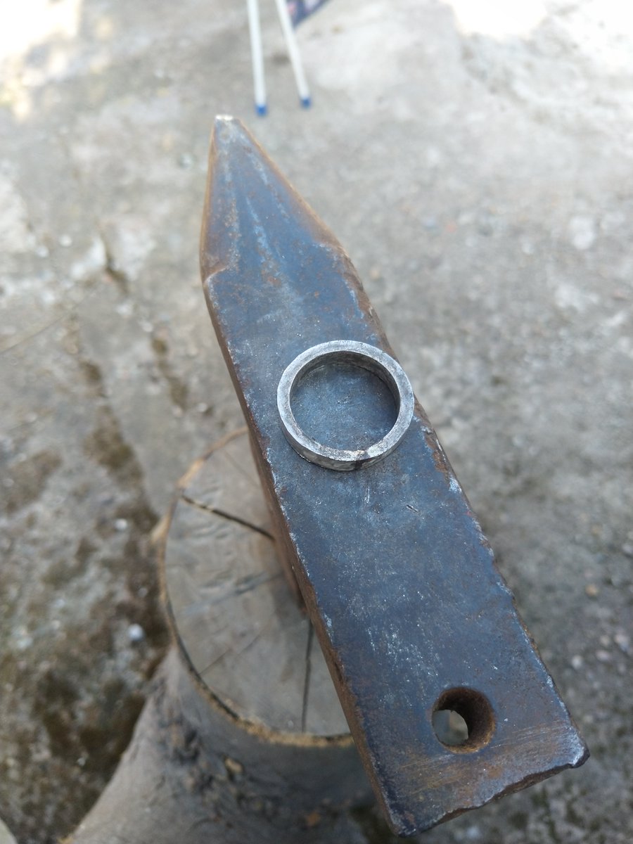 Using a tapered mandrel, the ring is shaped up and carefully hammered to the correct size. Consistent hammering and counting are very important. 16 strikes on one edge, 16 strikes on the other. You can do any number of strikes, but I had a childhood obsession with multiples of 4!