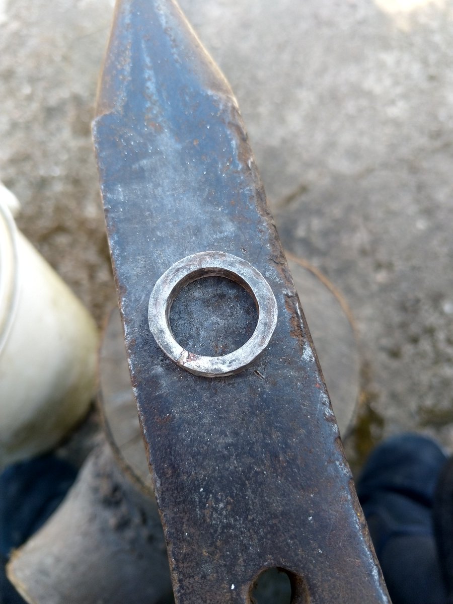 Using a tapered mandrel, the ring is shaped up and carefully hammered to the correct size. Consistent hammering and counting are very important. 16 strikes on one edge, 16 strikes on the other. You can do any number of strikes, but I had a childhood obsession with multiples of 4!